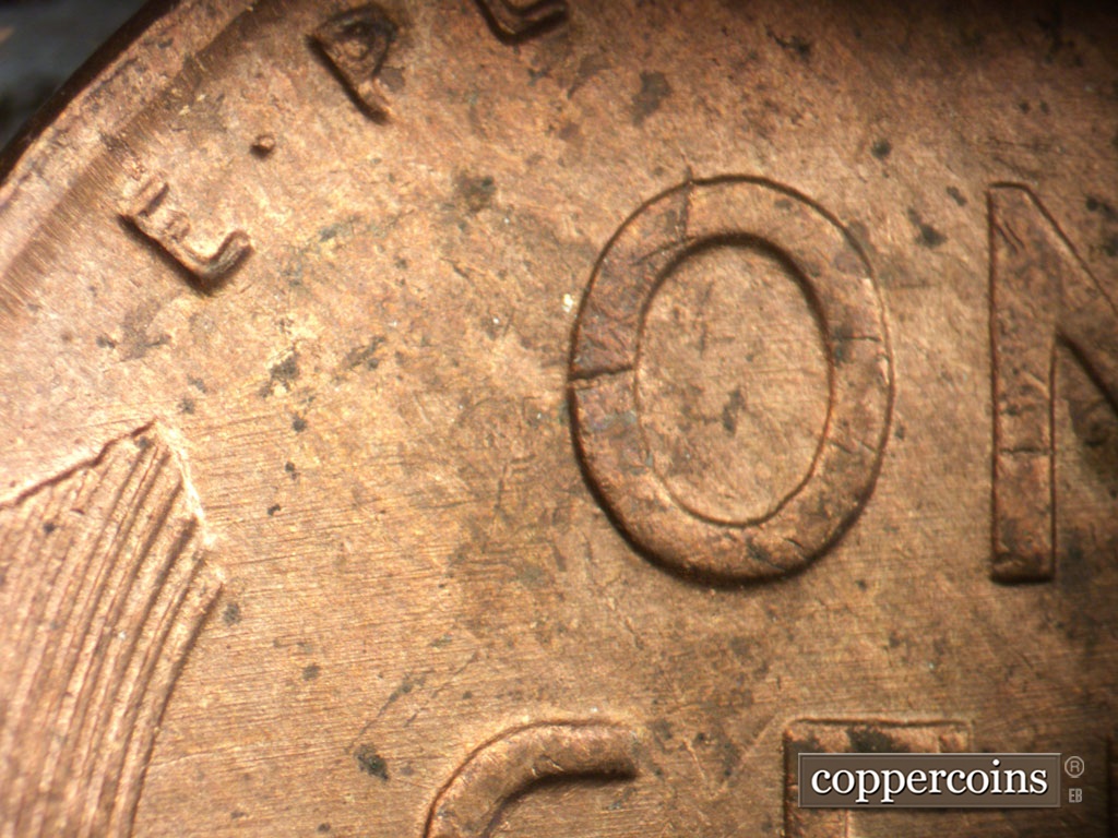 Die-stage C marker on 1954P•1DO•001 showing E/W die scratches through reverse.