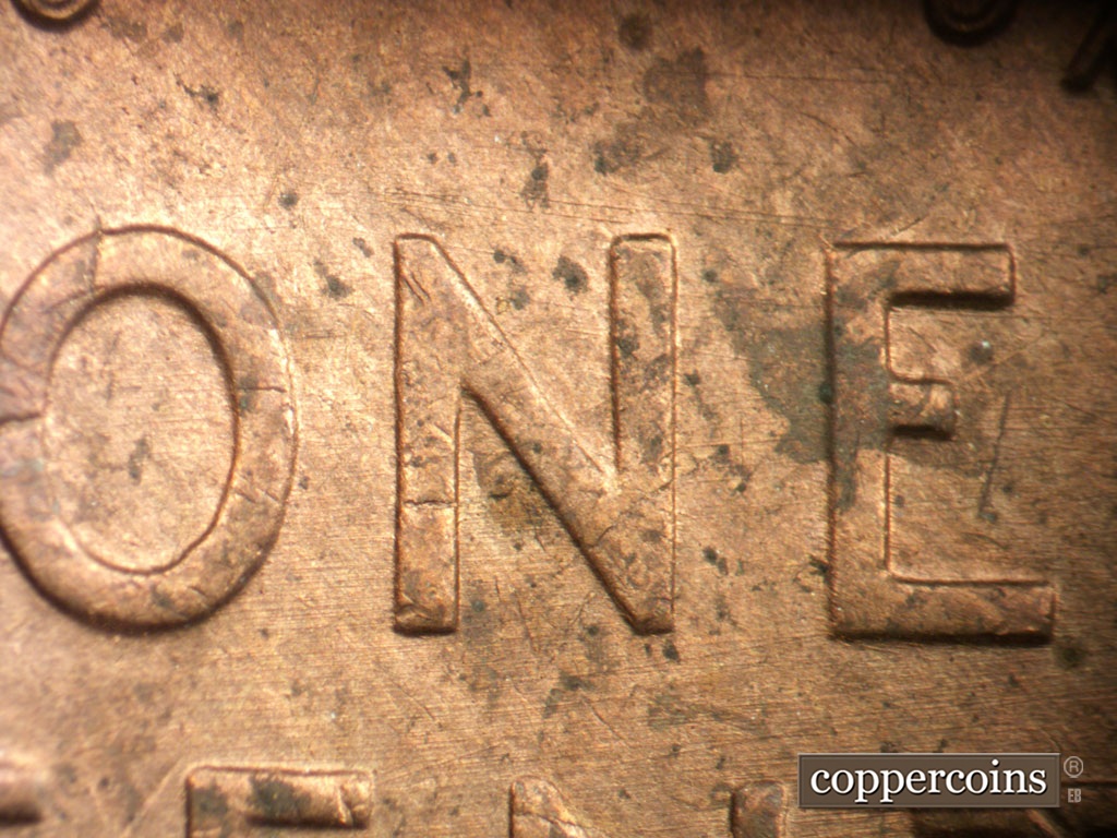 Die-stage C marker on 1954P•1DO•001 showing E/W die scratches through reverse.