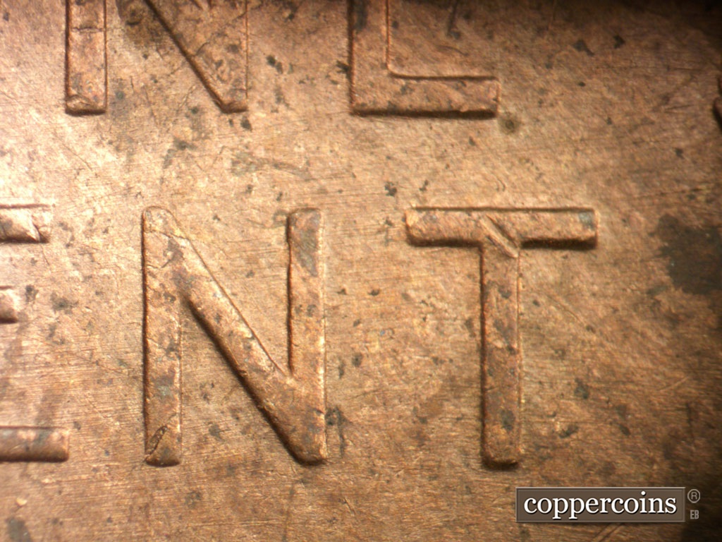 Die-stage C marker on 1954P•1DO•001 showing E/W die scratches through reverse.
