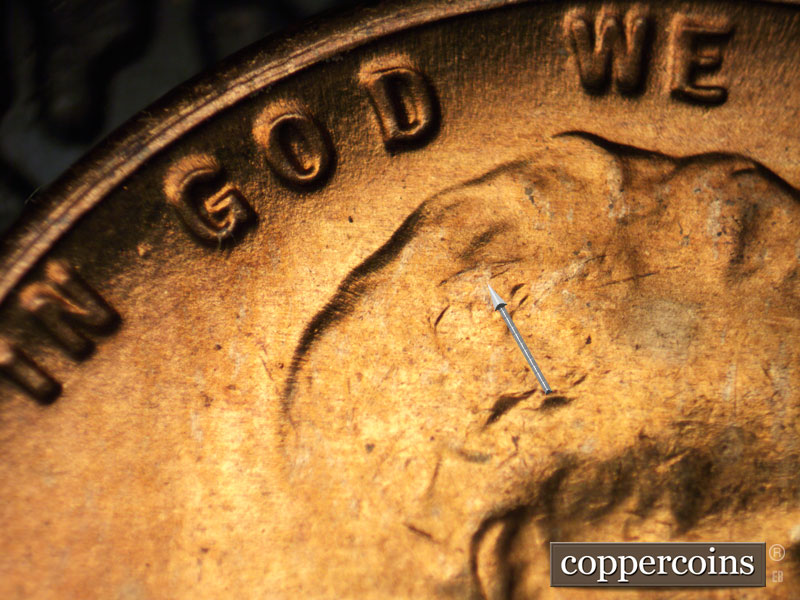 Die-stage C marker on 1954S•1MM•002 showing A die crack shows in the hair.