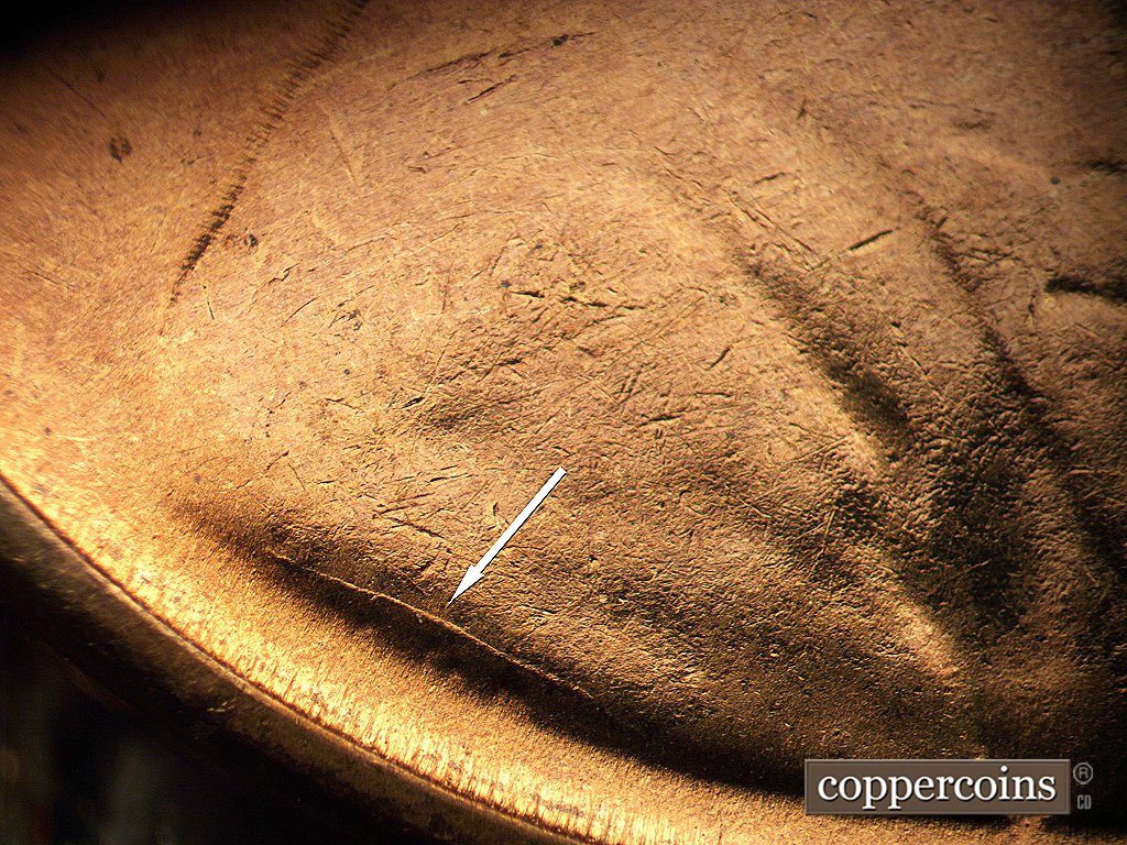 Die-stage D marker on 1954S•1MM•002 showing Die crack above VDB.