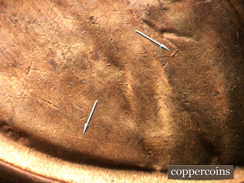 Die-stage B marker on 1954S•1MM•007 showing Die gouge on lapel. Die scratch on shoulder.
