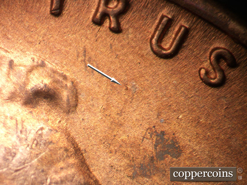Die-stage B marker on 1954S•1MM•007 showing A die dot shows in the field between the forehead and the U of TRUST.