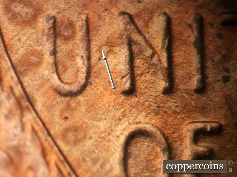 Die-stage B marker on 1954S•1MM•007 showing E-W Die scratches show around the UN of UNITED.