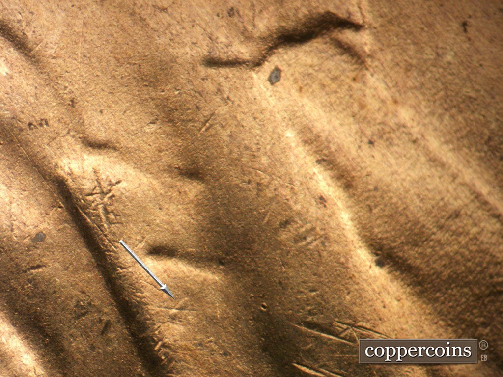 Die-stage D marker on 1954S•1MM•007 showing Worn die gouge still visible on lapel.