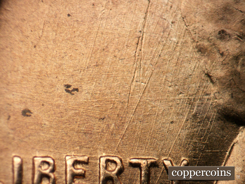 Die-stage B marker on 1955D•1DO•008 (1955 Doubled Die Obverse).