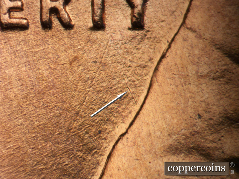 Die-stage B marker on 1955D•1DO•014 (1955 Doubled Die Obverse).