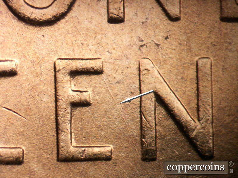 Die-stage B marker on 1955D•1DO•014 (1955 Doubled Die Obverse).