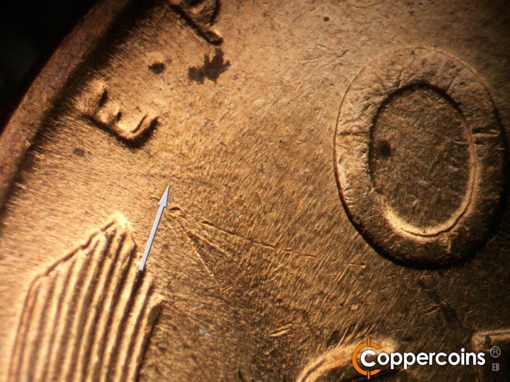 Die-stage C marker on 1955D•1DO•015 showing Worn die scratch under E in E PLURIBUS.