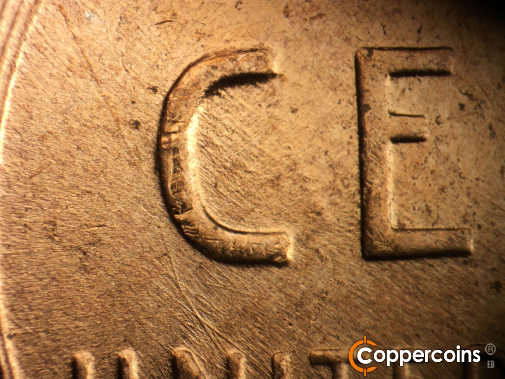 Die-stage C marker on 1955D•1DO•015 showing Unique die scratch from left wheat stalk to N in UNITED.