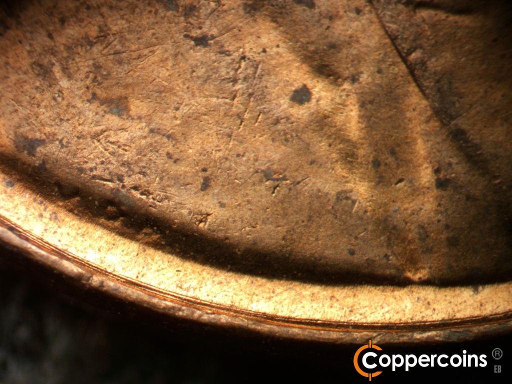 Die-stage B marker on 1955D•1DO•016 showing Concentric die scratch between rim and VDB.
