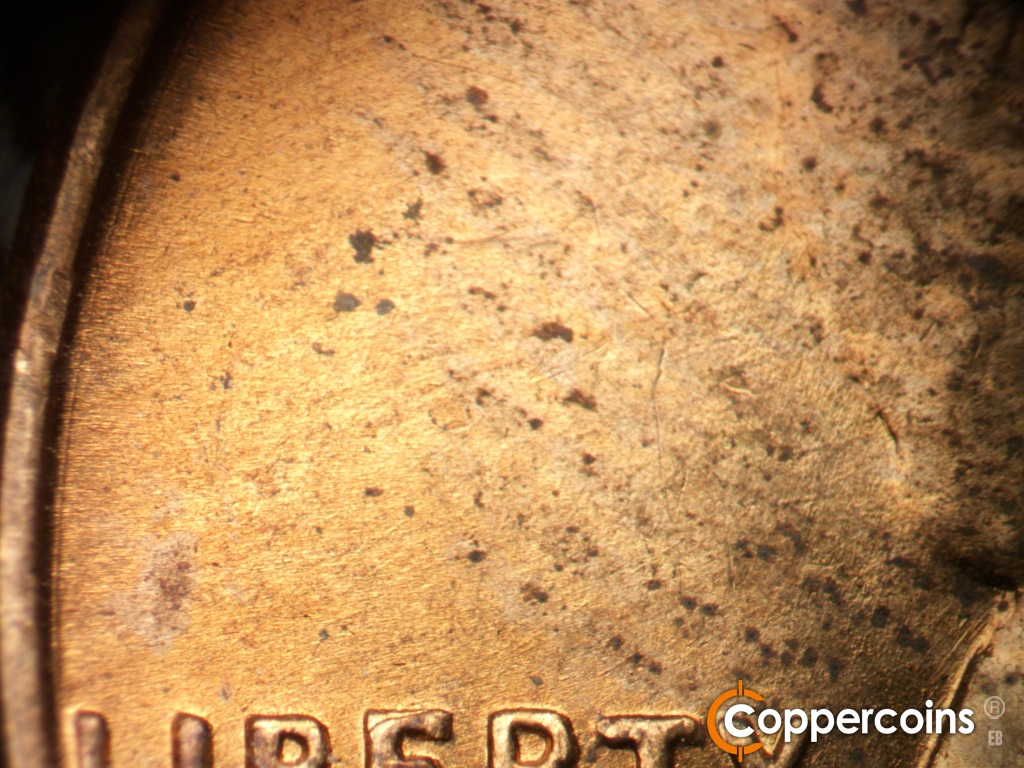 Die-stage B marker on 1955D•1DO•016 showing Concentric die scratch near rim.