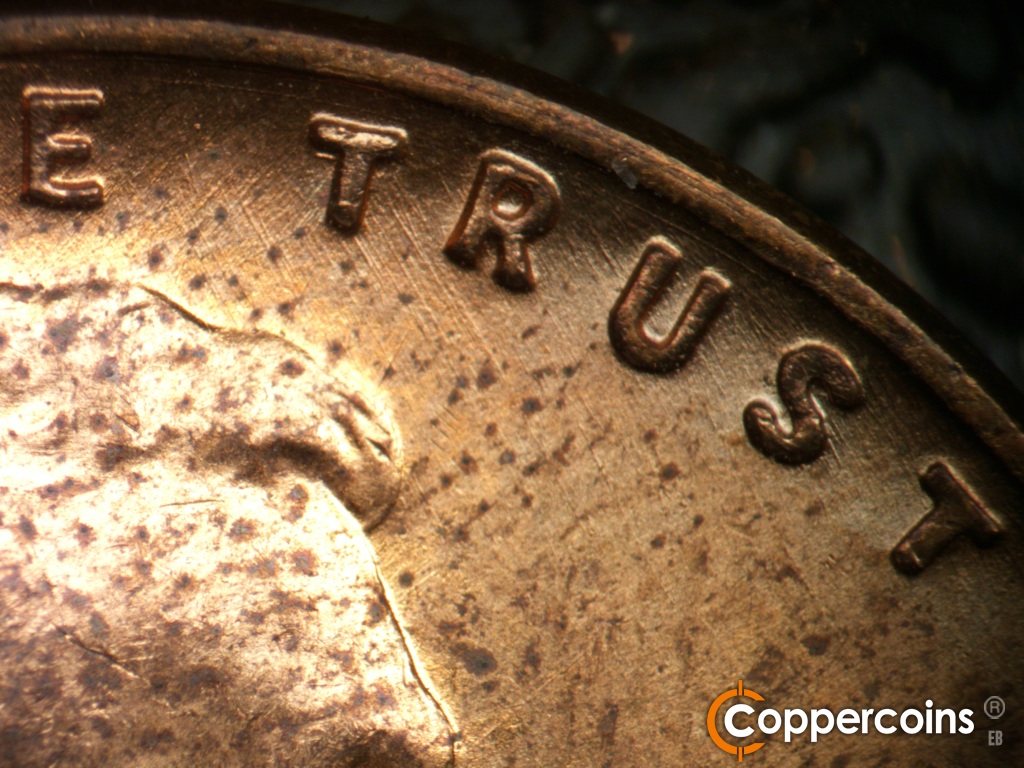 Die-stage B marker on 1955D•1DO•016 showing Concentric die scratch between rim and TRUST. SE die scratches through TRUST.