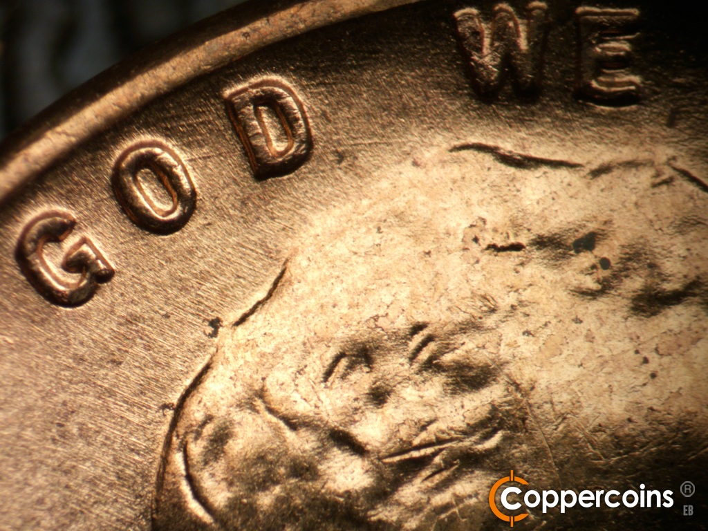 Die-stage B marker on 1955D•1DO•017 showing Light concentric die scratches through GOD.