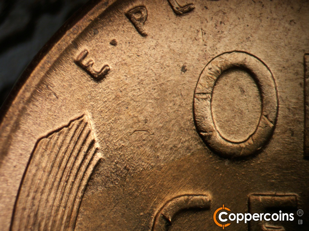 Die-stage B marker on 1955D•1DO•017 showing Light concentric die scratching though O in ONE.