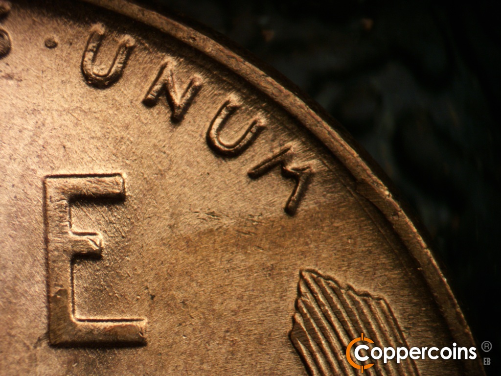 Die-stage B marker on 1955D•1DO•017 showing Concentric die scratch between rim and UNUM.