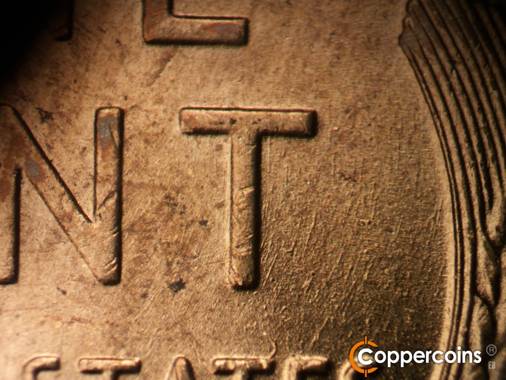 Die-stage B marker on 1955D•1DO•017 showing Concentric die scratches near of T in CENT.