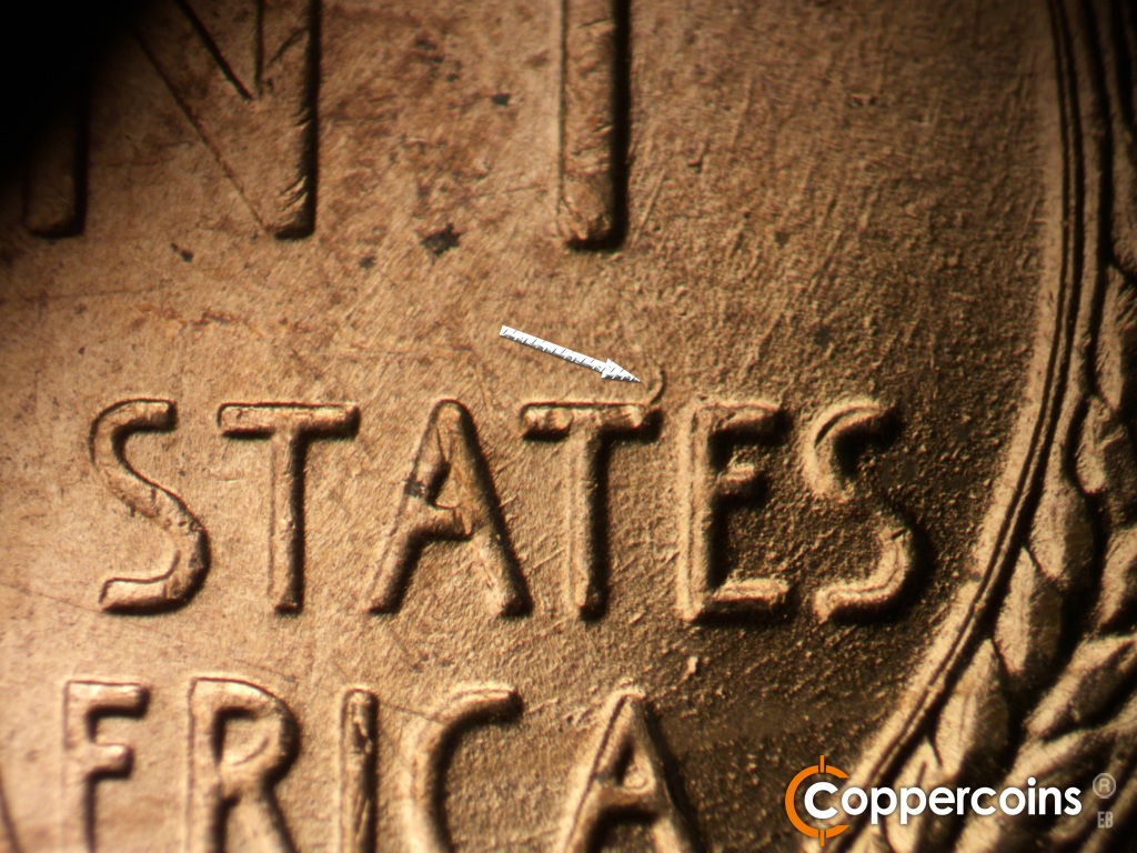Die-stage B marker on 1955D•1DO•017 showing Die gouge from top of second T in STATES.