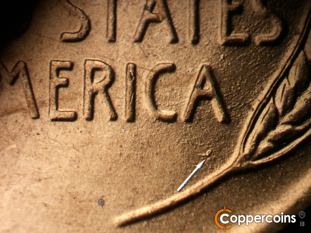 Die-stage B marker on 1955D•1DO•017 showing Diie gouge in field under last A in AMERICA.