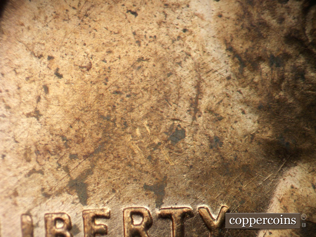 Die-stage B marker on 1955D•1MM•003 showing NE die scratches in field above LIBERTY.