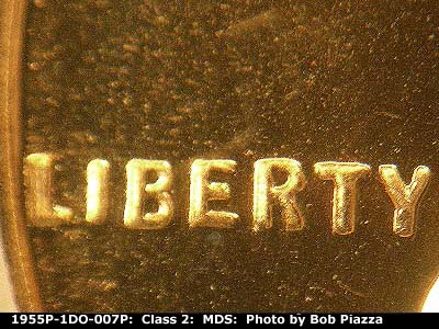 Die-stage B marker on 1955P•1DO•007P showing Doubling shows strongly in and around the word liberty.