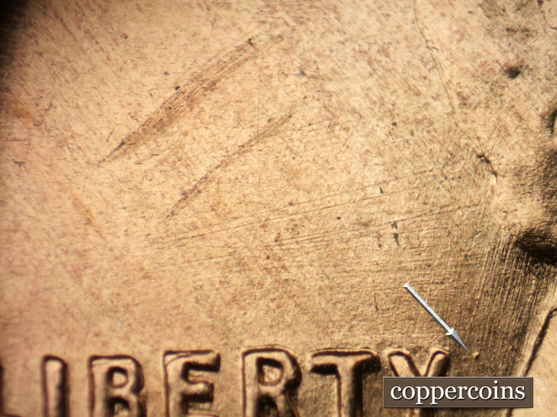 Die-stage B marker on 1955S•1DO•002 (1955 Doubled Die Obverse).