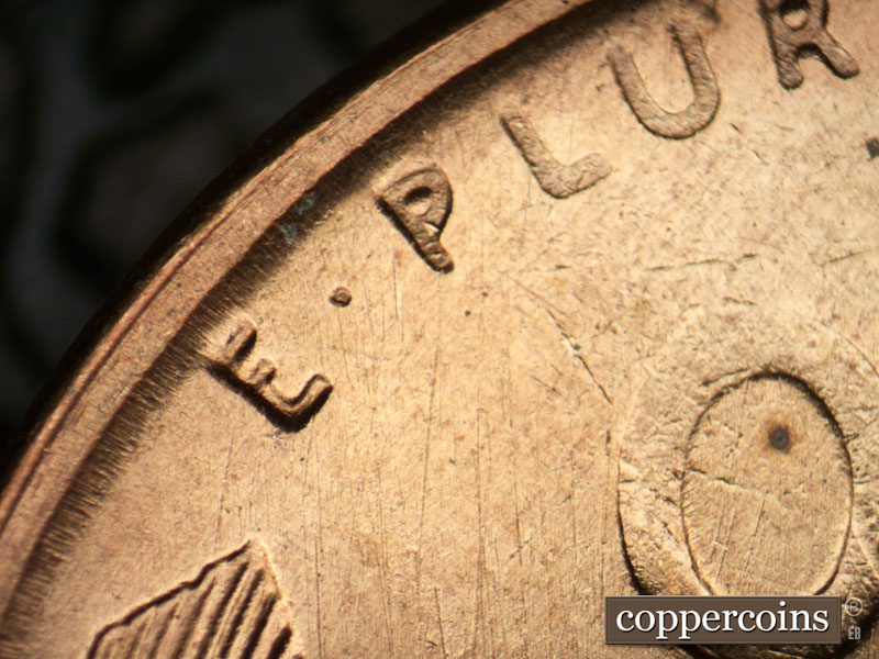 Die-stage B marker on 1955S•1DO•002 (1955 Doubled Die Obverse).
