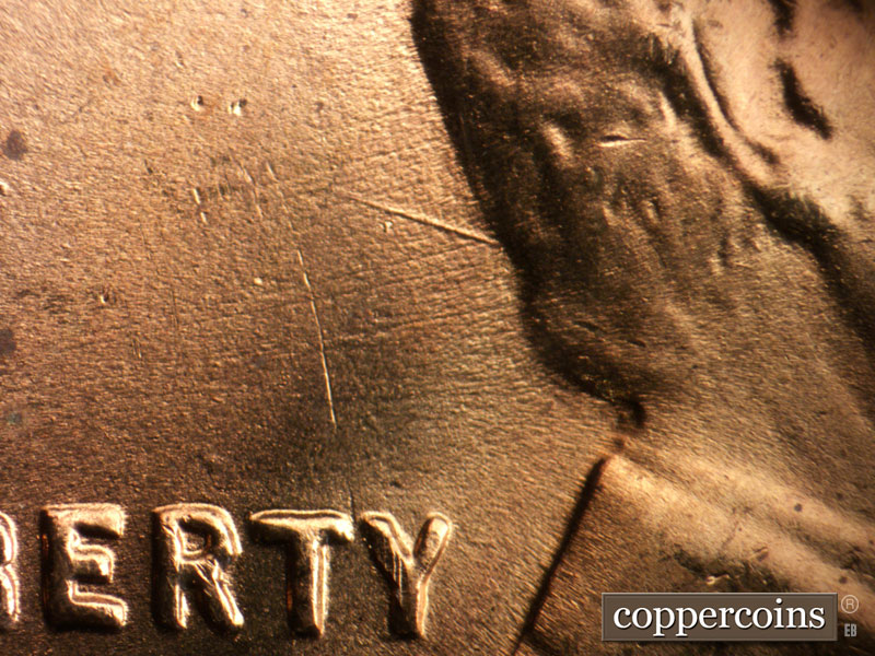Die-stage B marker on 1955S•1DO•003 (1955 Doubled Die Obverse).