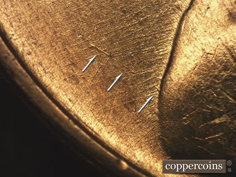 Die-stage B marker on 1955S•1MM•002 showing Heavy NE die scratch in field west of shoulder.