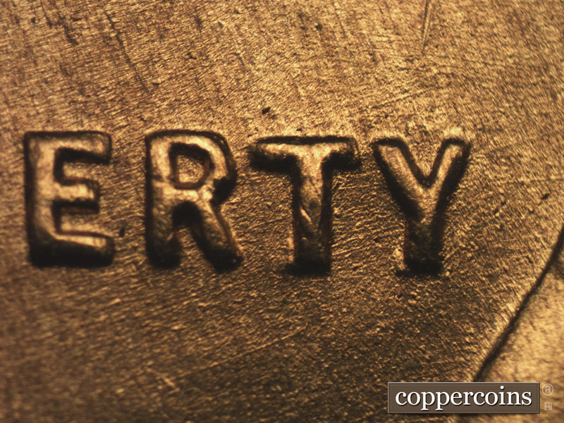 Die-stage B marker on 1955S•1MM•002 showing ENE die scratches through RTY in LIBERTY.