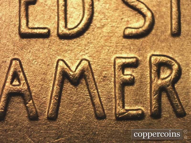 Die-stage B marker on 1955S•1MM•002 showing Concentric die scratches through AMERICA.