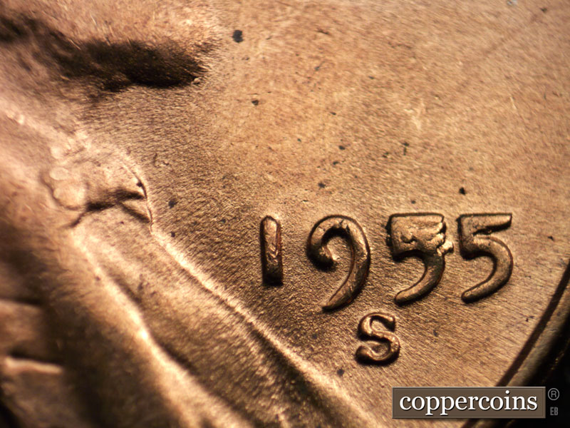 Die-stage C marker on 1955S•1MM•002 showing A large die chip can be seen in the first 5 of the date, and a smaller one in the last 5 of the date.