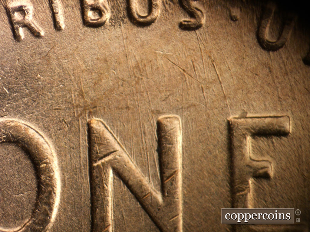 Die-stage A marker on 1955S•1MM•019 showing Heavy die scrates from BUS in PLURIBUS down through NE in ONE.