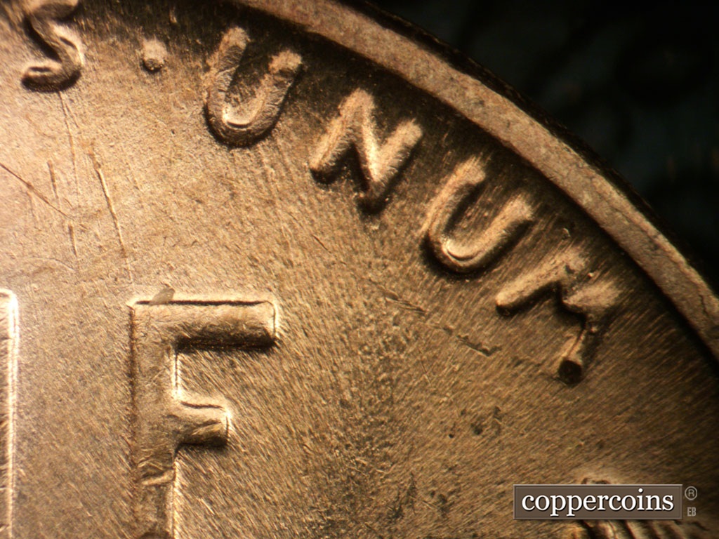Die-stage A marker on 1955S•1MM•019 showing Worn die scratches from UN in UNUM.