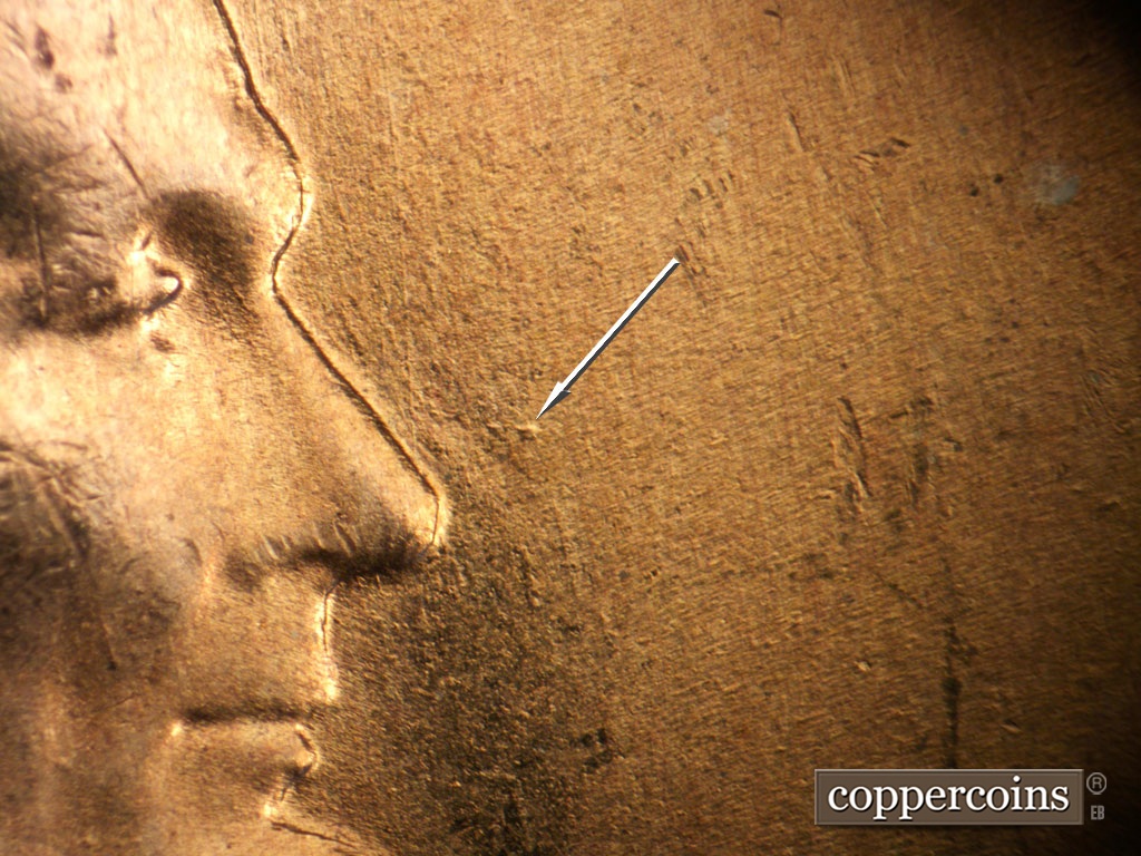 Die-stage B marker on 1955S•1MM•019 showing Die dot in front of nose.