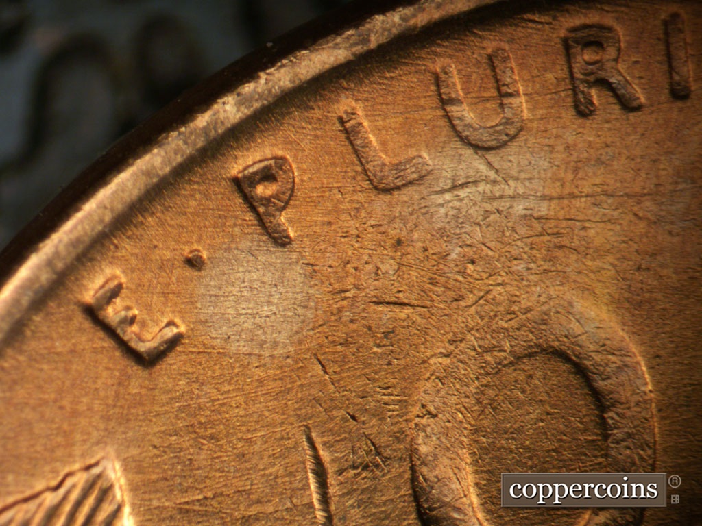 Die-stage B marker on 1955S•1MM•019 showing Die scratches through E PLURIBUS.