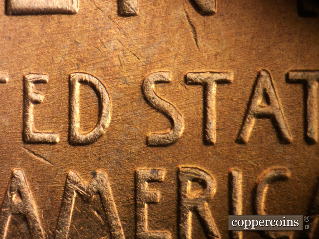 Die-stage B marker on 1955S•1MM•019 showing ENE die scratches throughout center of reverse.