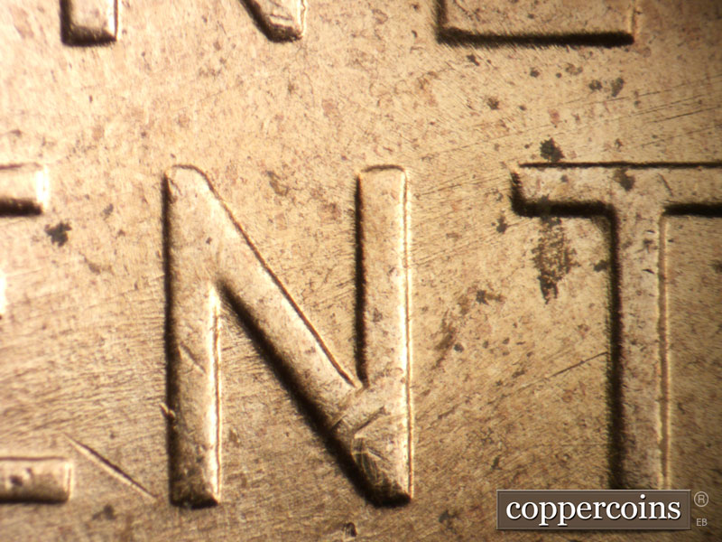 Die-stage B marker on 1956D•1DO•026 (1956 Doubled Die Obverse).