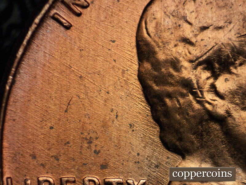 Die-stage B marker on 1956D•1DO•028 (1956 Doubled Die Obverse).