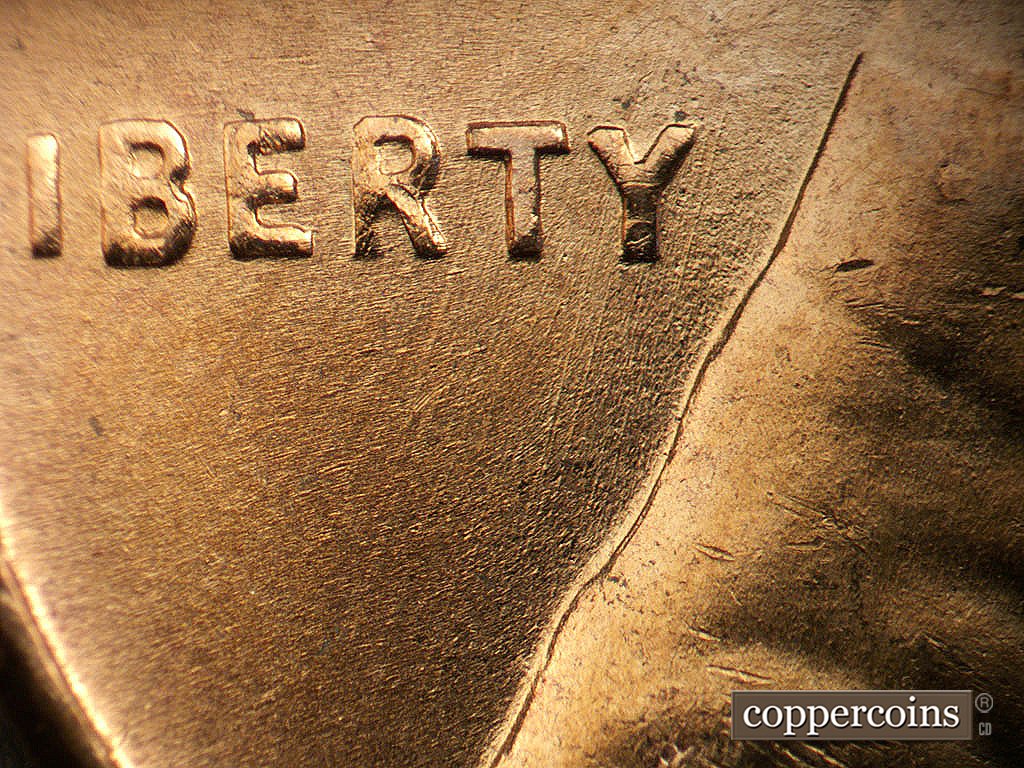 Die-stage B marker on 1956D•1DO•045 showing SSW die scratches through RTY in LIBERTY.