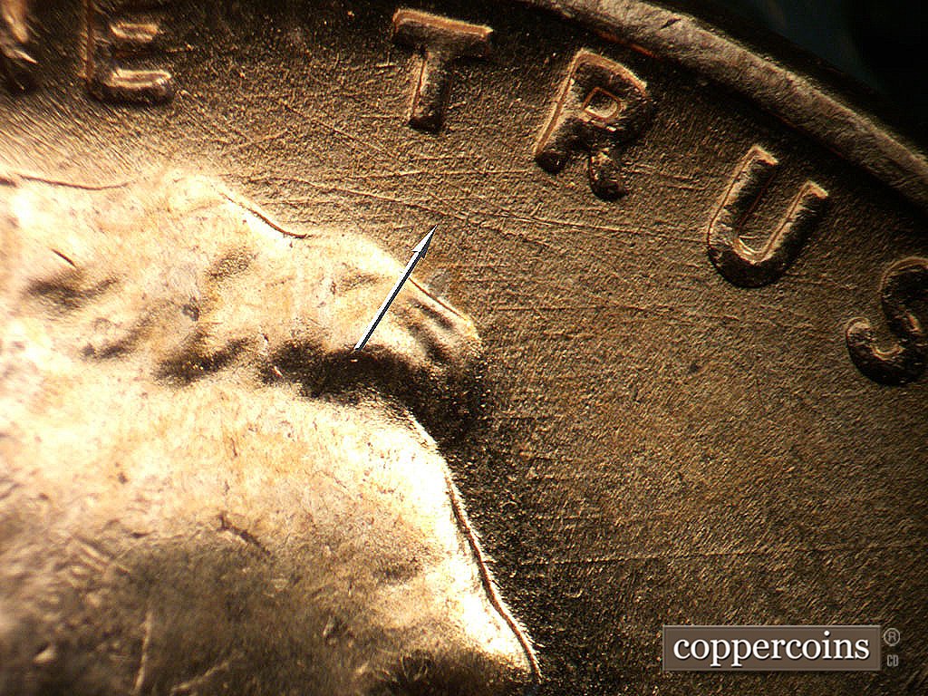 Die-stage B marker on 1956D•1DO•045 showing Curved die scratch under TR in TRUST.