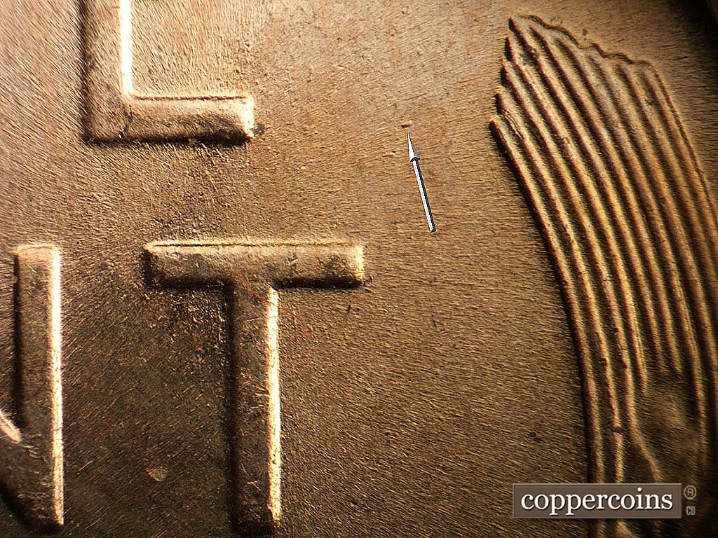 Die-stage B marker on 1956D•1DO•045 showing Die dot in field between E in ONE and left wheat stalk.