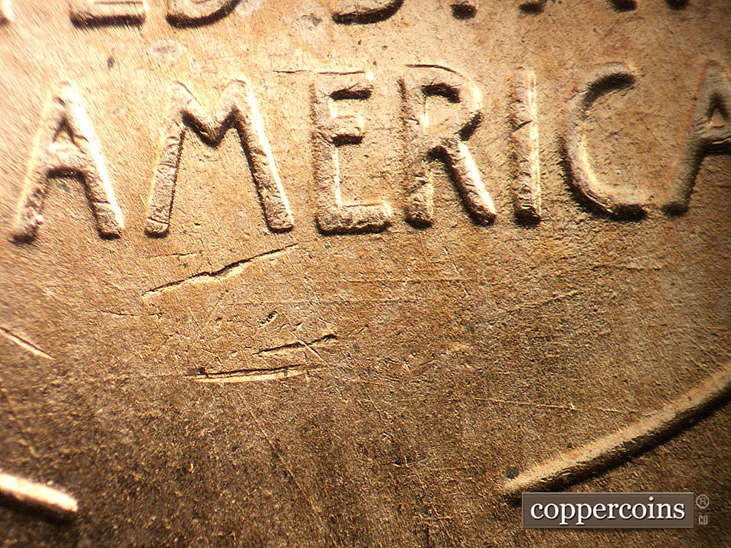 Die-stage B marker on 1956D•1DO•045 showing E/W die scratches under ER in AMERICA.