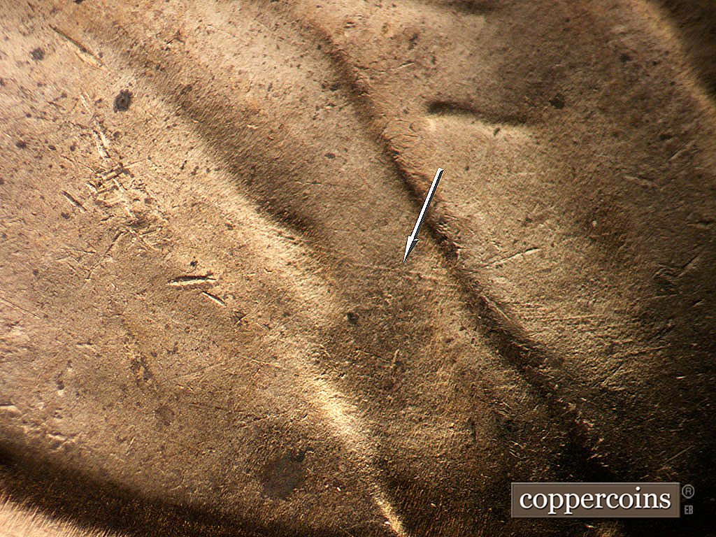 Die-stage B marker on 1956D•1DO•046 showing ESE die scratch on jacket.