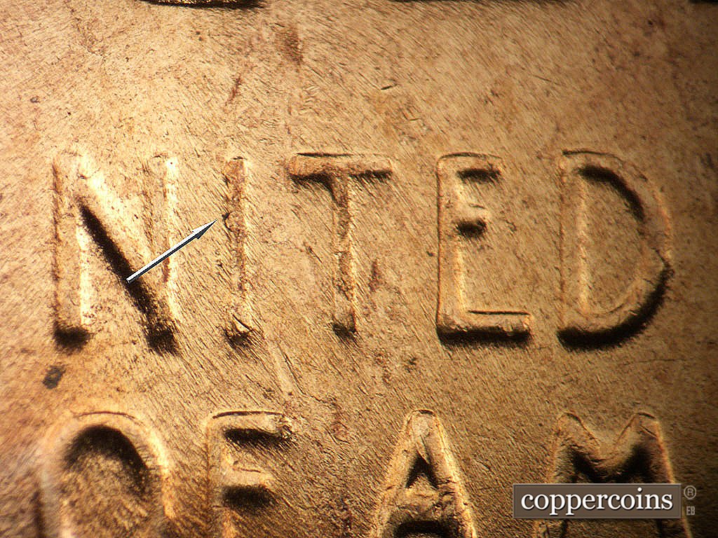 Die-stage B marker on 1956D•1DO•048 showing Die crack along left side of I in UNITED.