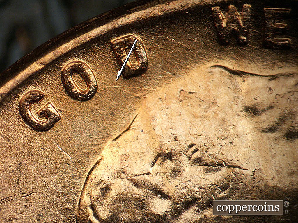 Die-stage B marker on 1956D•1MM•011 showing Die scratch connect O nGOD to top of hair.
