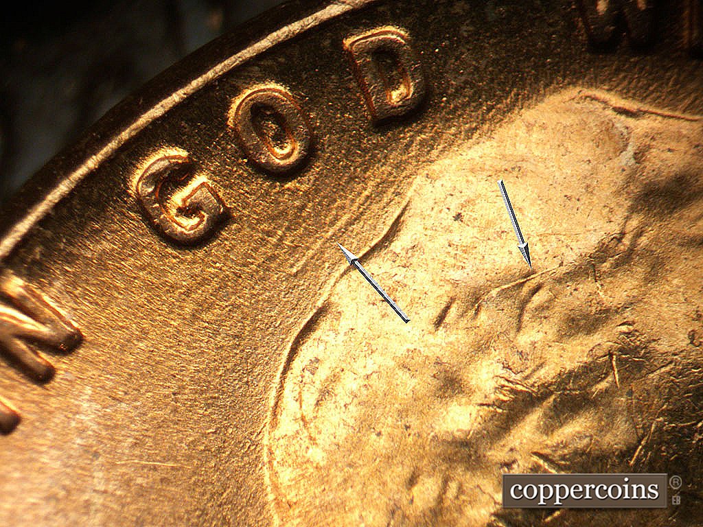 Die-stage C marker on 1956D•1MM•023 showing NE die scratch in field between GOD and hair.