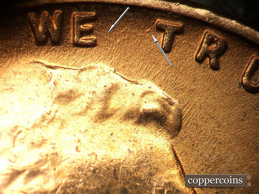 Die-stage C marker on 1956D•1MM•023 showing Weak SE die scratch fro E in WE, Die dot near first T in TRUST.