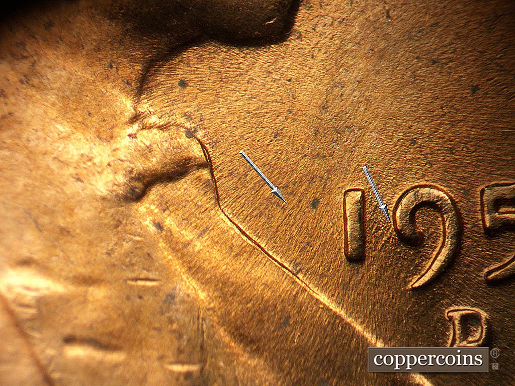 Die-stage C marker on 1956D•1MM•023 showing NE die scratch from lapel.