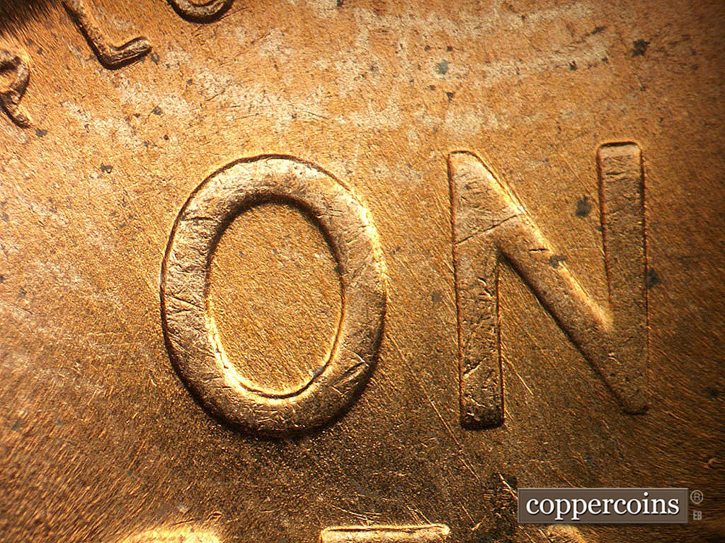 Die-stage C marker on 1956D•1MM•023 showing Light SE die scratches through ONE.